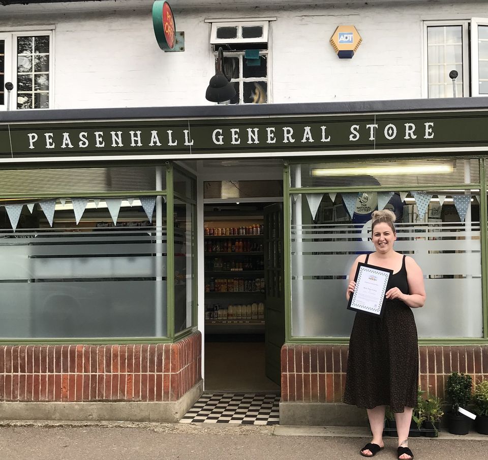 Peasenhall General Stores exterior and staff member receiving their More Than A Shop certificate