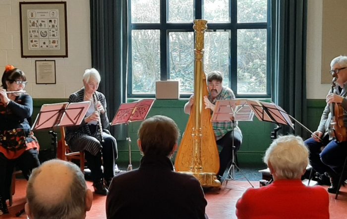 photo of musicians from the Suffolk Philharmonic playing to an audience in Somersham Village Hall