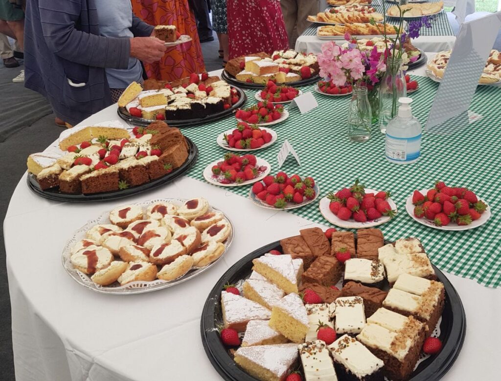 RCC 20th Anniversary - table filled with buffet of strawberries and slices of cake