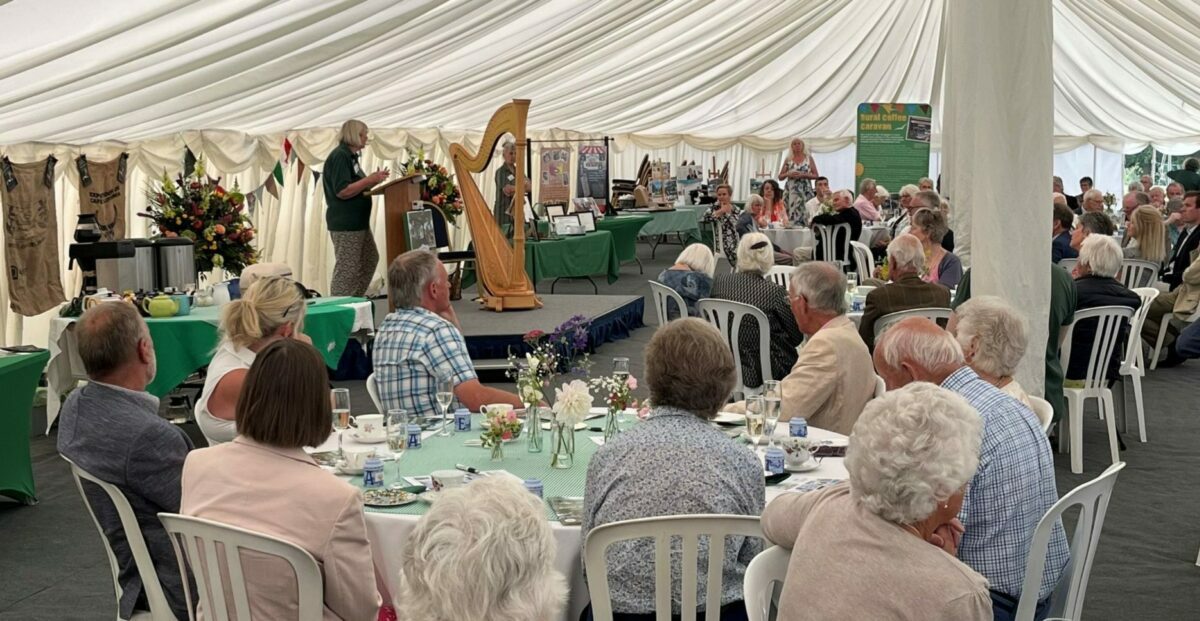 photo showing RCC chief exec giving a speech in front of invited guests at the RCC 20th anniversary fundraiser at Old Buckenham Hall