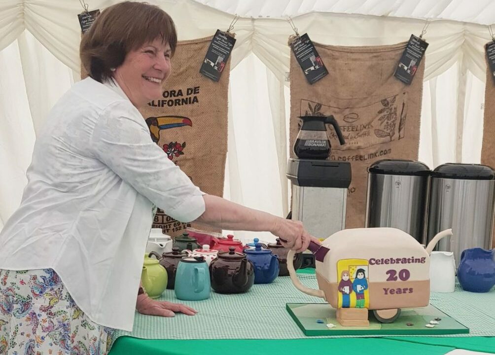 Photo showing Clare, Countess of Euston cutting a specially made cake in the form of the RCC logo for the RCC 20th Anniversary event.