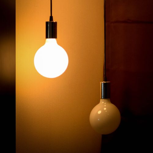 image of two light bulbs, one switched on, one off