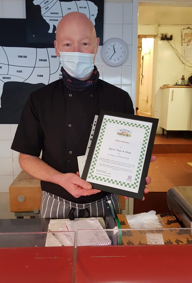 Kevin of Allens Butchers receiving their More Than A Shop certificate