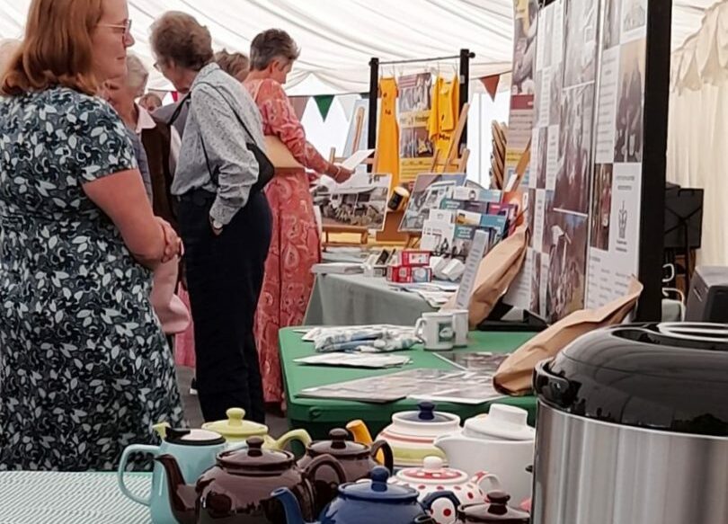 photo showing guests examining the RCC 20th Anniversary displays and archive exhibition at the fundraiser event at Old Buckenham Hall, and also tepots and tea urn at the ready