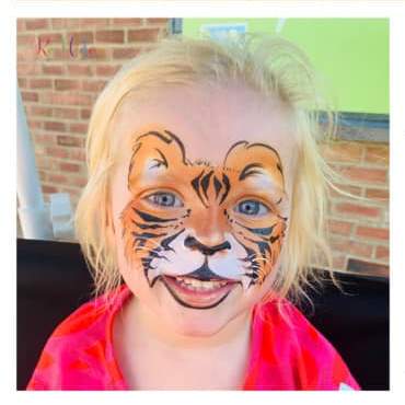 photo of child with tiger face paint by Rooblidoo