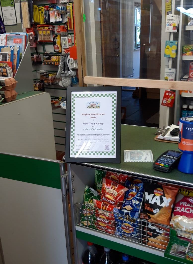 Photo of Rougham Post Office's More Than A Shop certificate on the shop counter