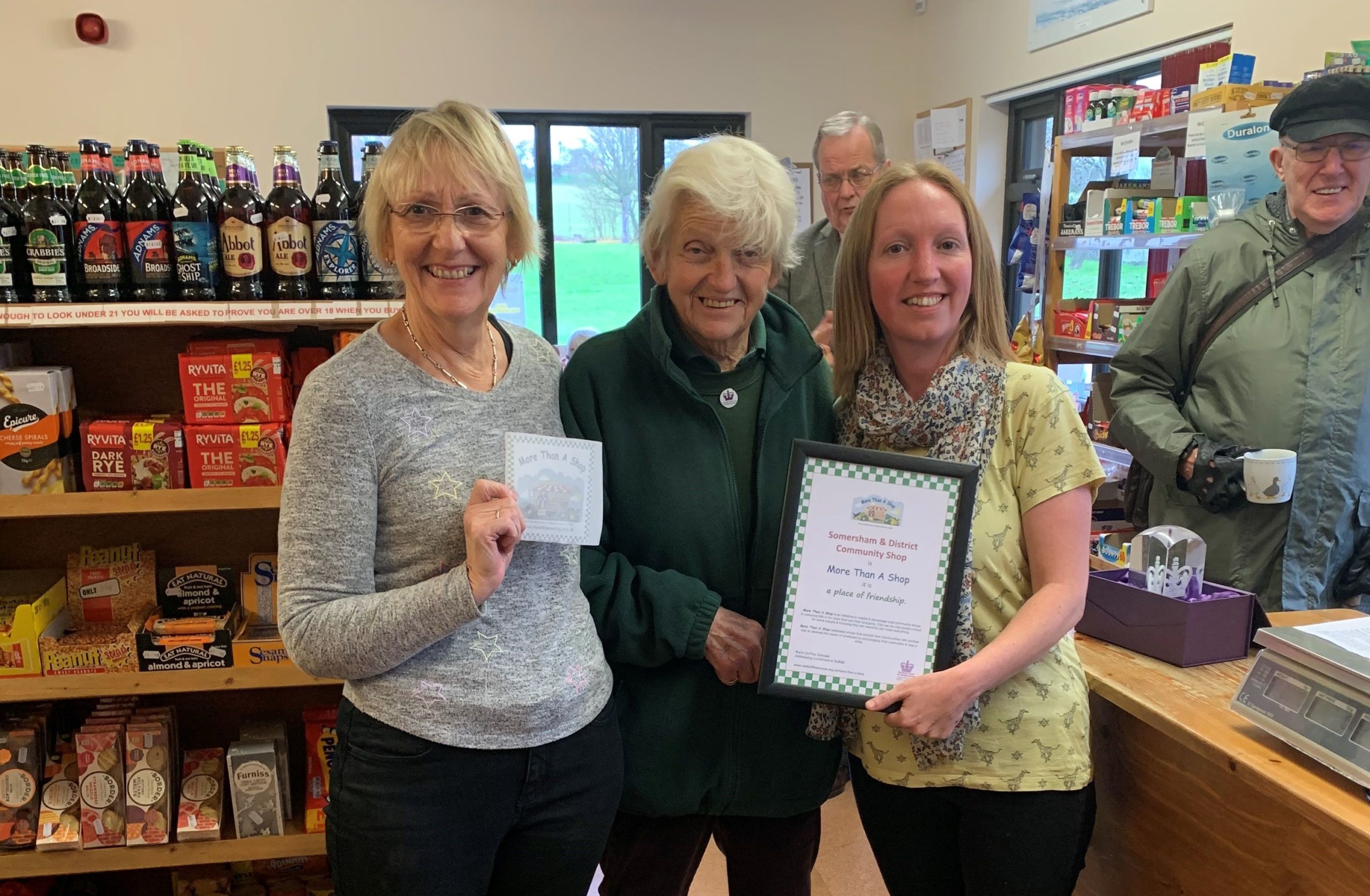 photo of Sally Fogden awarding a More Than A Shop certificate