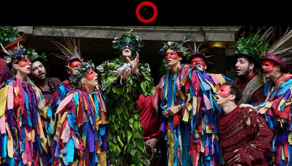 photo of actors in colourful costumes grouped together on stage in Shakespeare's Globe recorded production of The Two Noble Kinsmen