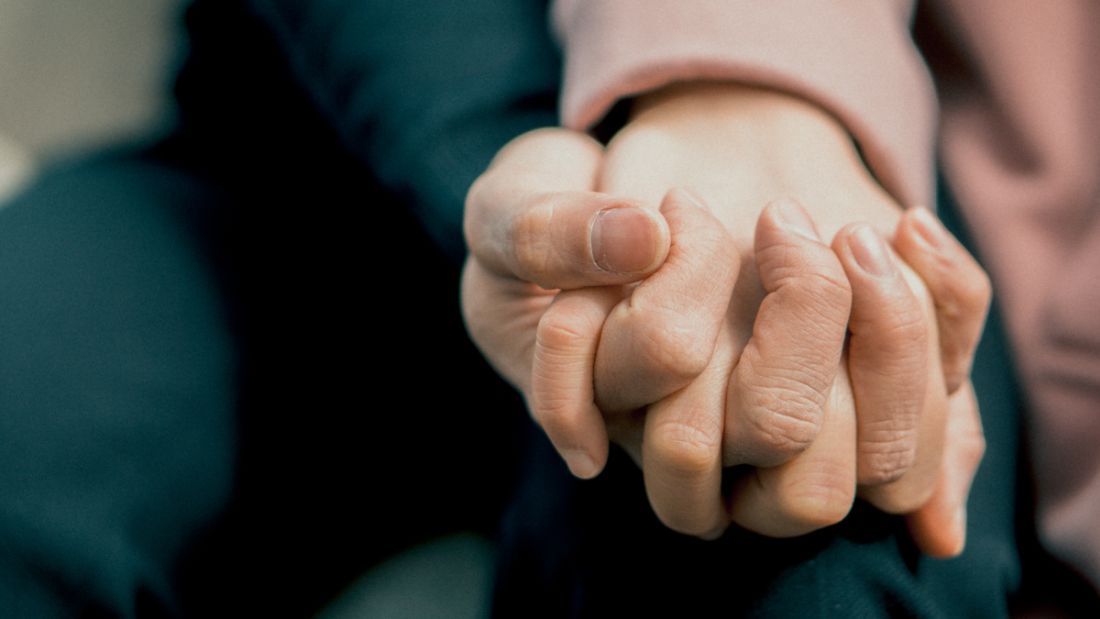image of two people's hands holding each other's