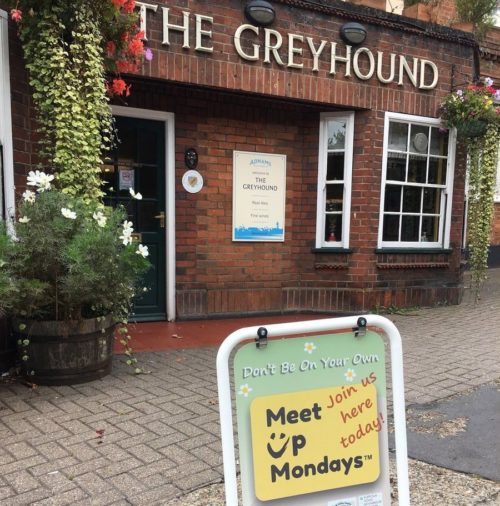 square LOCATIONS 2 photo of The Greyhound pub with MeetUpMondays pavement swing sign out fromt